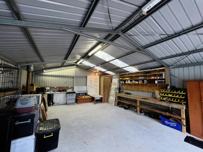 An organised Hobart shed with clear floor space, a workbench and neatly arranged tools